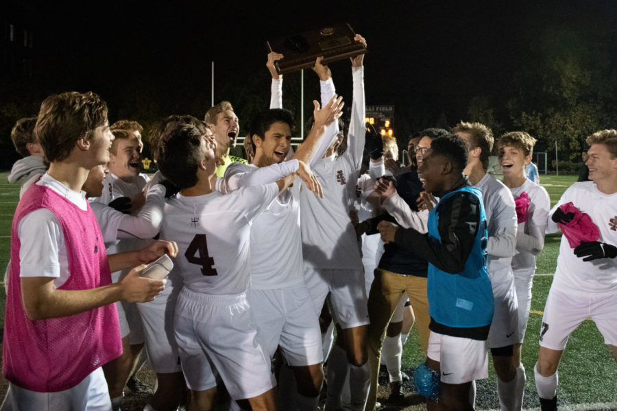 The team celebrates their win around the sectional title trophy
