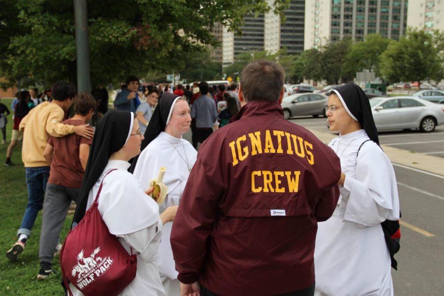 Sisters of SICP talk the walk with Father Caruso. 