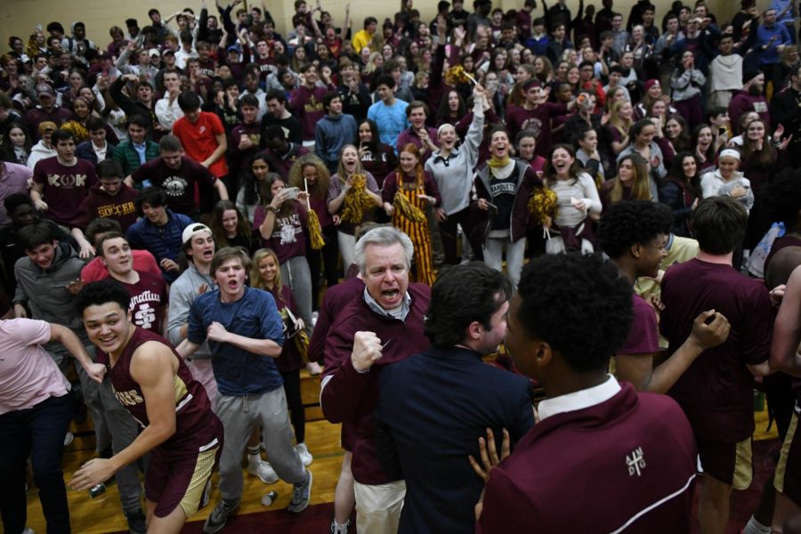 The crowd rushes the court during the Ignatius vs. DePaul game.
