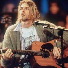 Kurt Cobain playing guitar with Nirvana on MTV Unplugged